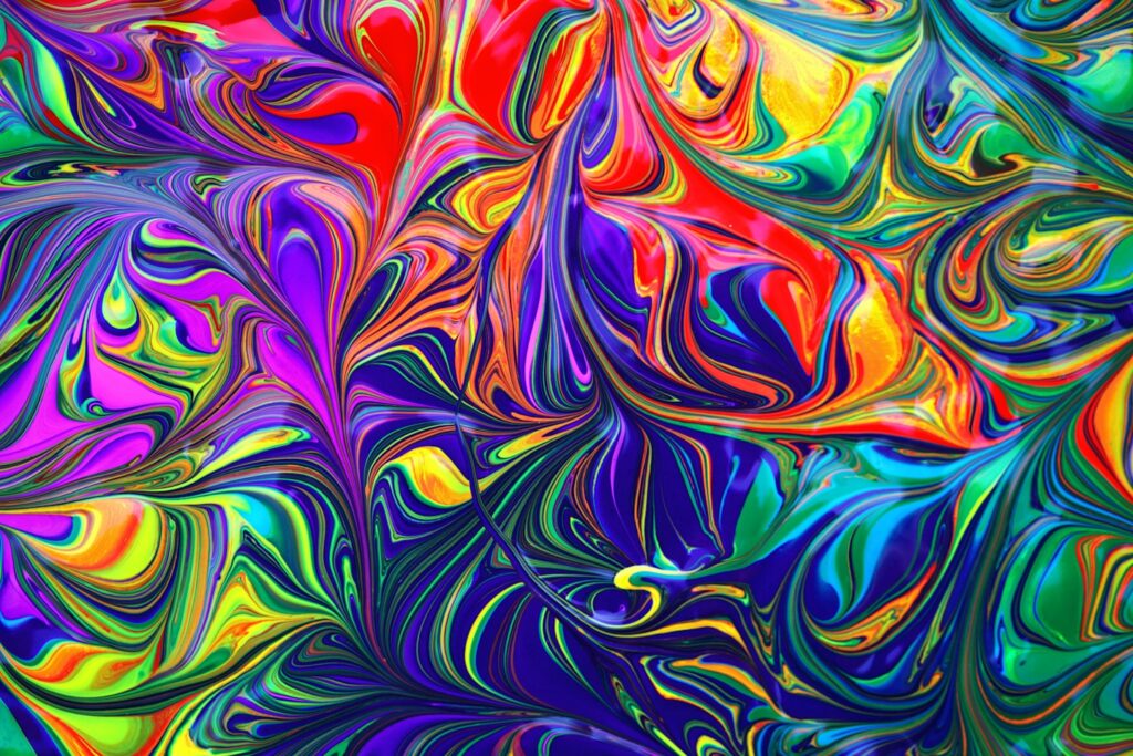 Psychedelic colorful rainbow paint wallpaper background.